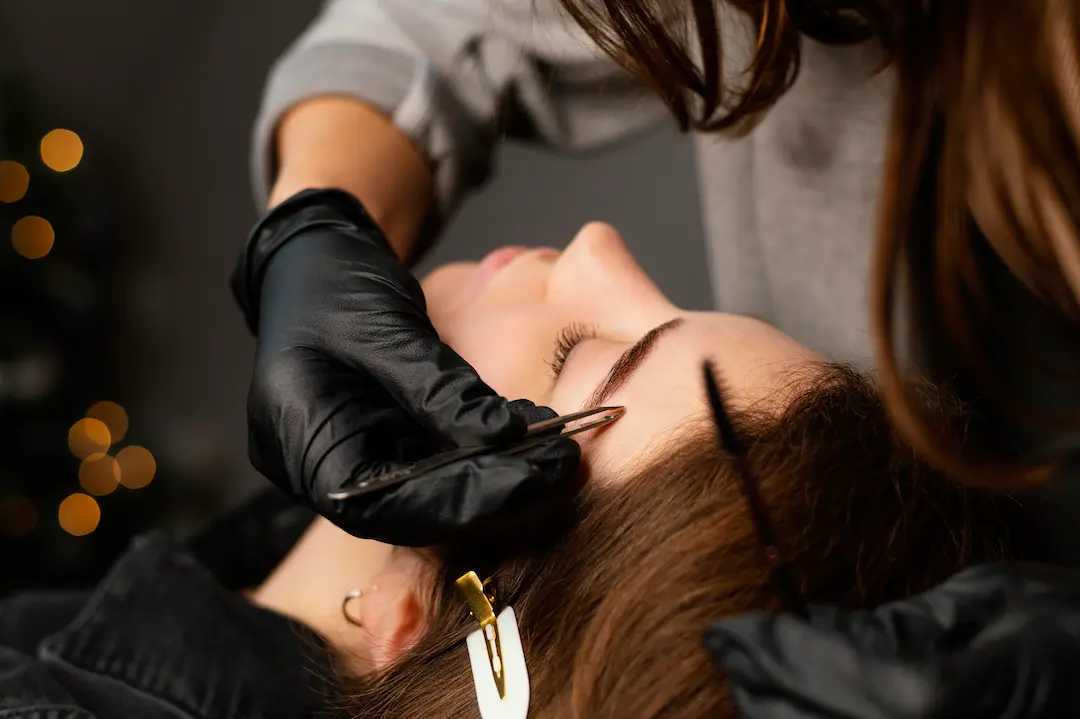 front-view-female-specialist-doing-eyebrow-treatment-woman