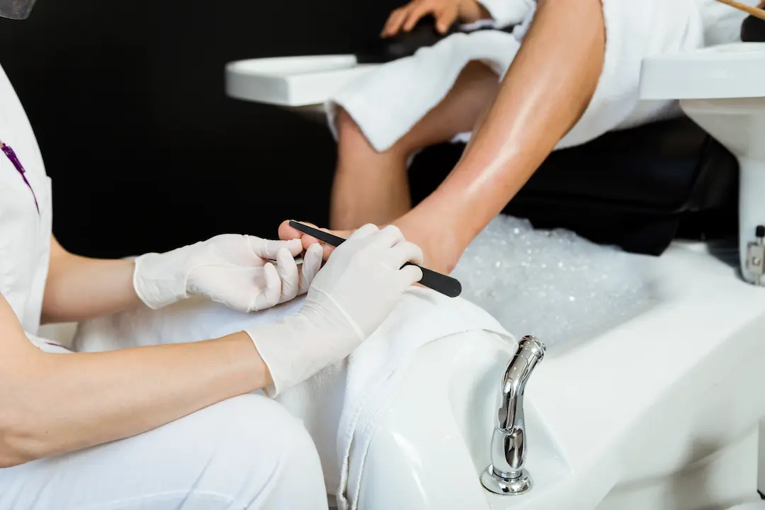 young-man-doing-pedicure-salon-beauty-concept